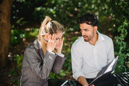 两名同事在户外会议上讨论业务问题