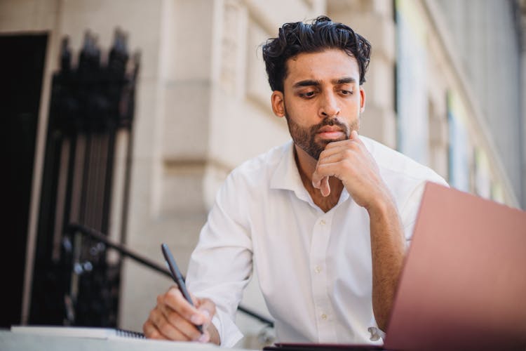 Man Sitting Outside Working On Laptop