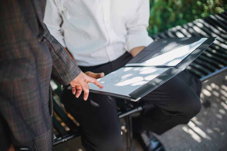 Person Pointing A Finger On A Document 