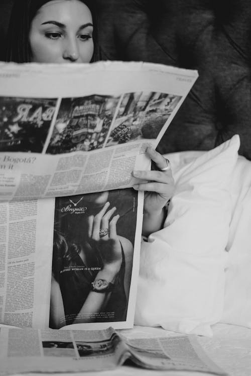 Free A Woman Reading the Newspaper Stock Photo