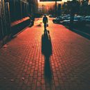 Person Walking on Sidewalk during Night Time