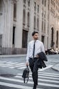 Man in White Dress Shirt and Black Pants Standing on Pedestrian Lane