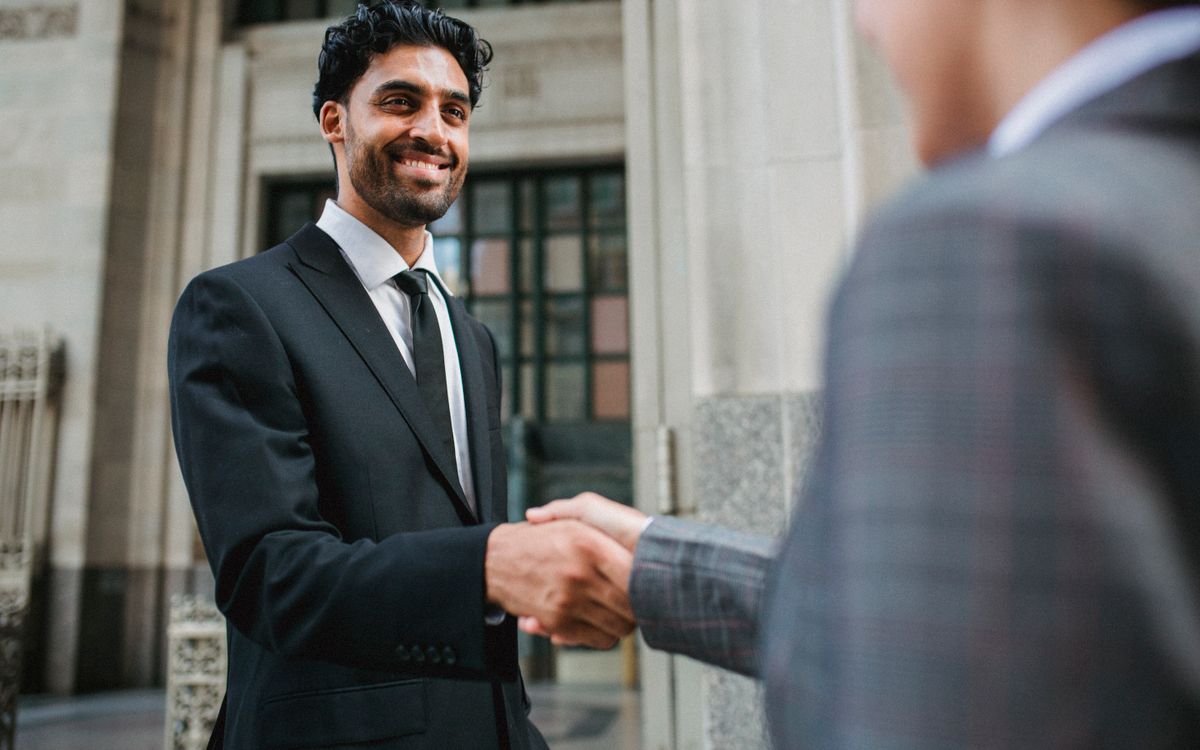 Indian professionals shaking hands on a deal