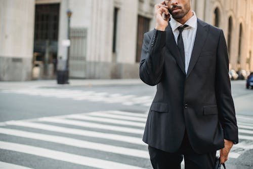 A Man in Black Suit Jacket Standing on the Street