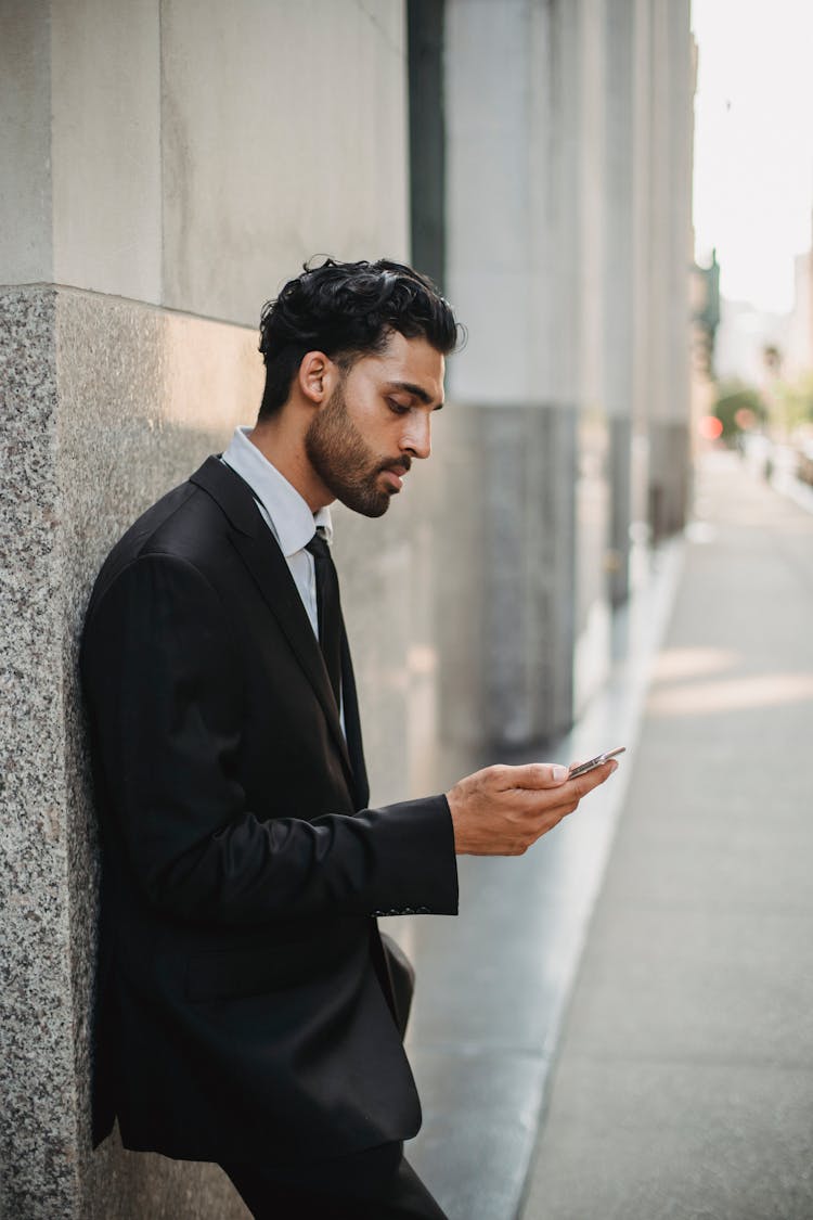 Businessman In Suit Working From Phone