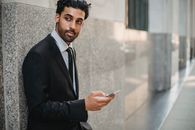 Man in Black Suit Holding Smartphone