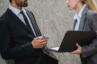 Man in Black Suit Holding Black Tablet Computer