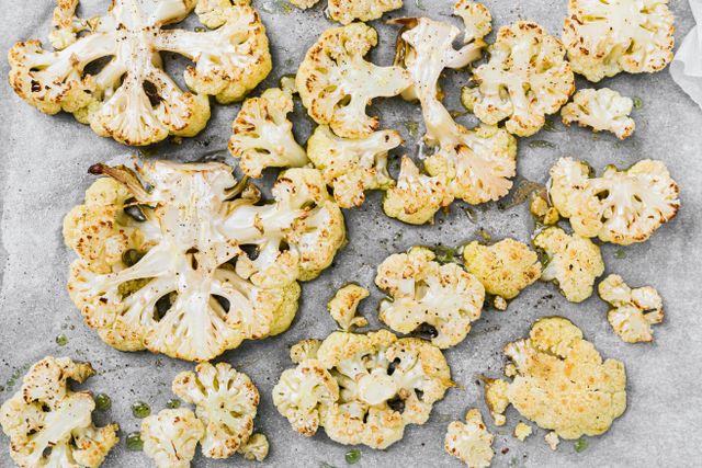 Roasted cauliflower steaks on a baking tray — photo by Kaboompics on Pexels