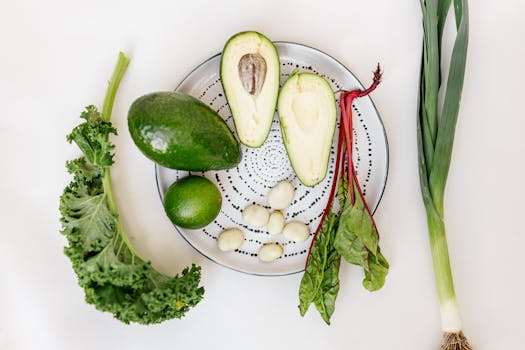 A vibrant flat lay of fresh vegetables and avocado on a plate.