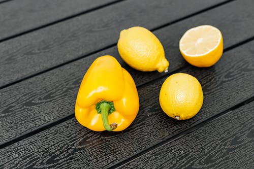 Close-up Photo of Pepper and Sliced Lemon 