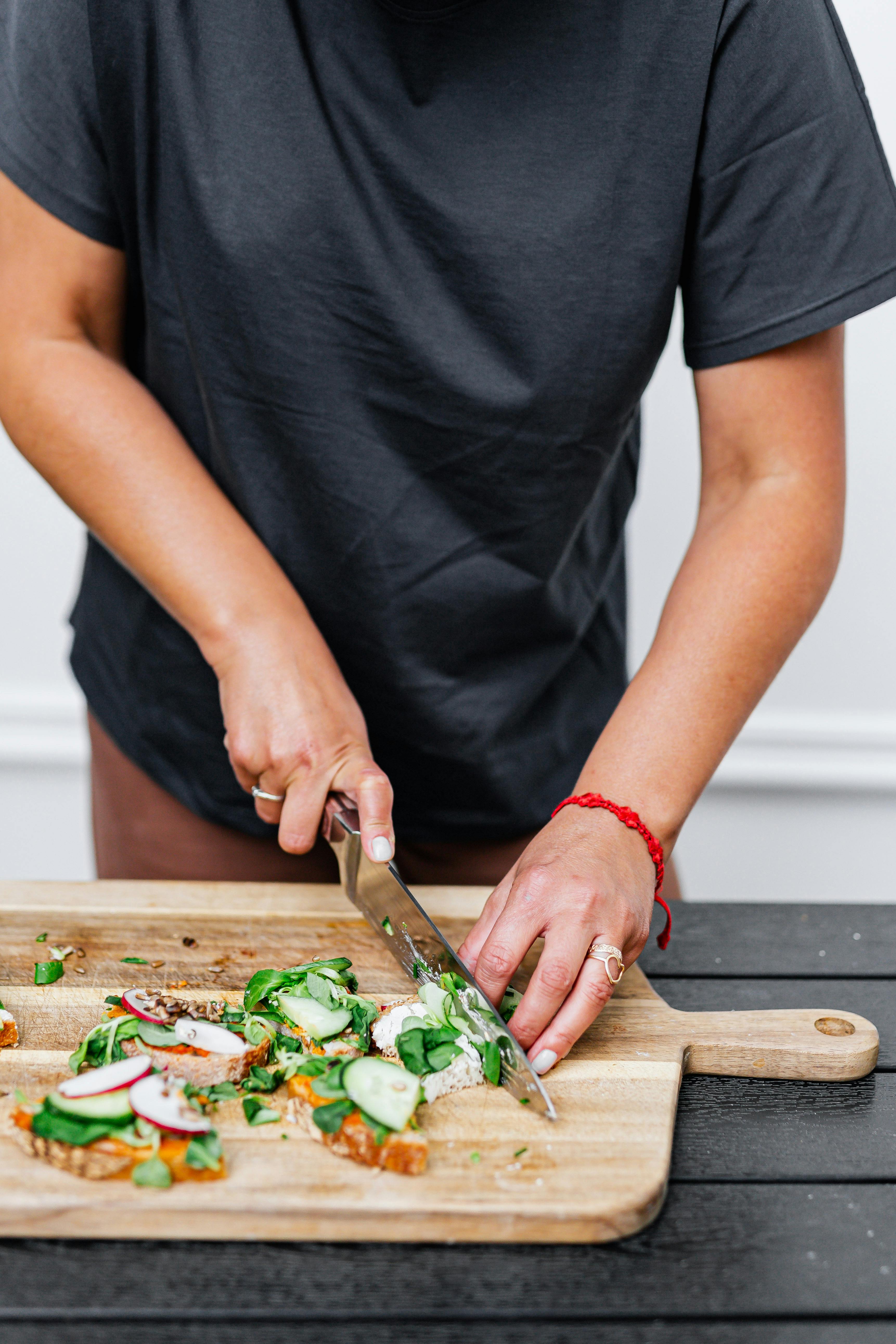 Hands Of A Young Woman Chopping Vegetables On A Wooden Board Stock Photo,  Picture and Royalty Free Image. Image 25488318.