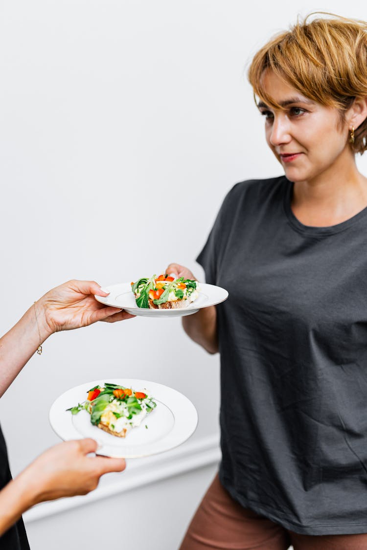 Woman Holding A Plate Of Food 