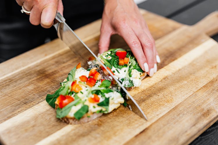 Photo Of A Person Slicing A Healthy Sandwich