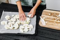 Person Holding Black Tray With White Mushrooms