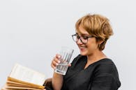 Smiling Woman with Water Glass and Book