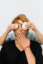 Hands Covering Woman Eyes with Vegetables