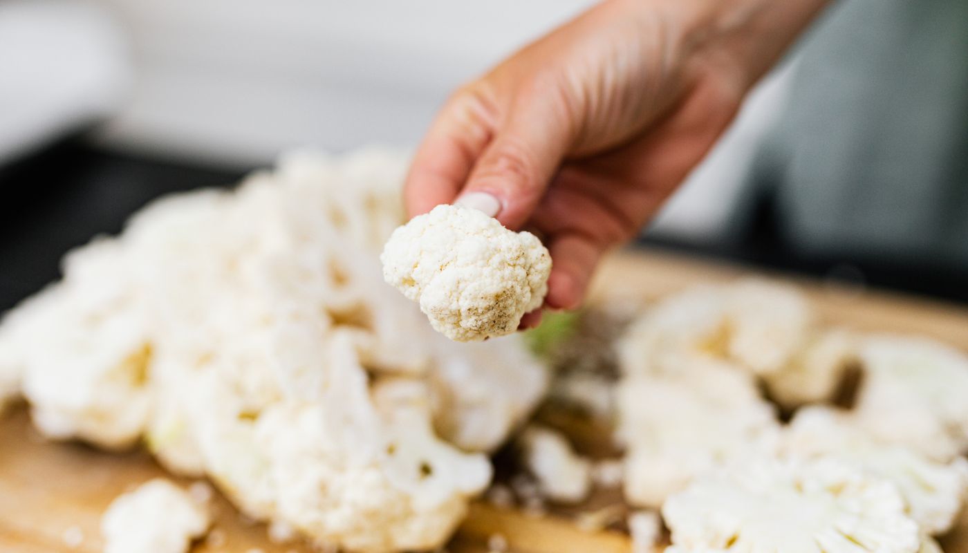 healthy cauliflower mousse — Single Cauliflower Rosette in Hand of Cook · Free. Photo: Pexels