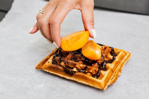 Free Brown Waffle with Sliced Orang Fruit on Top Stock Photo