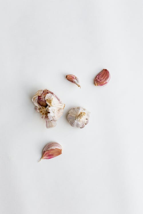 Free White and Brown Garlic Cloves on White Surface Stock Photo