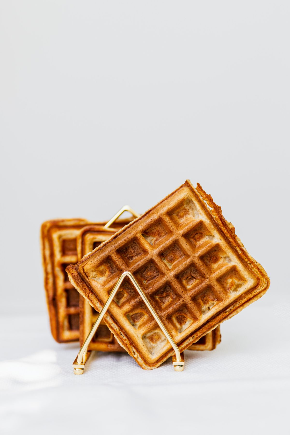 Golden square waffles standing separately in a metal holder