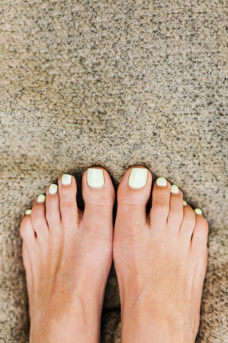 Close-up View Of Toes On Carpet