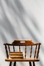 Brown Wooden Chair Beside White Wall