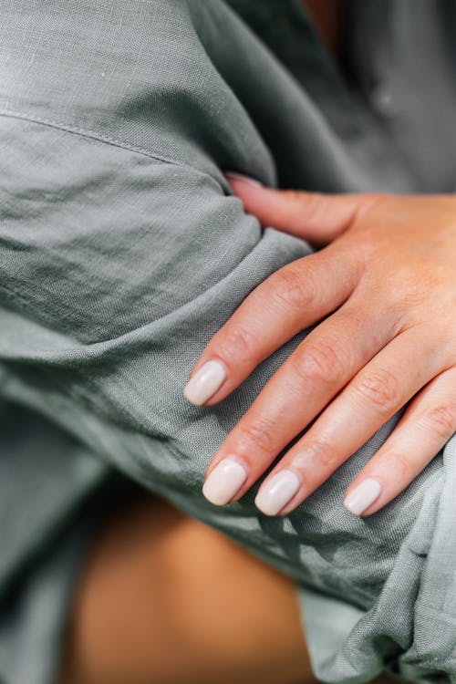 Hand Touching Arm in Shirt