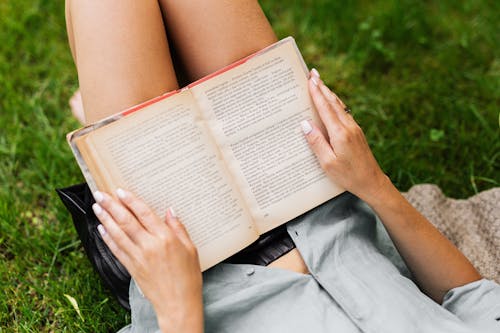 Hands of a Woman Holding a Book