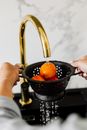 Person Holding Stainless Steel Kettle With Orange Fruits