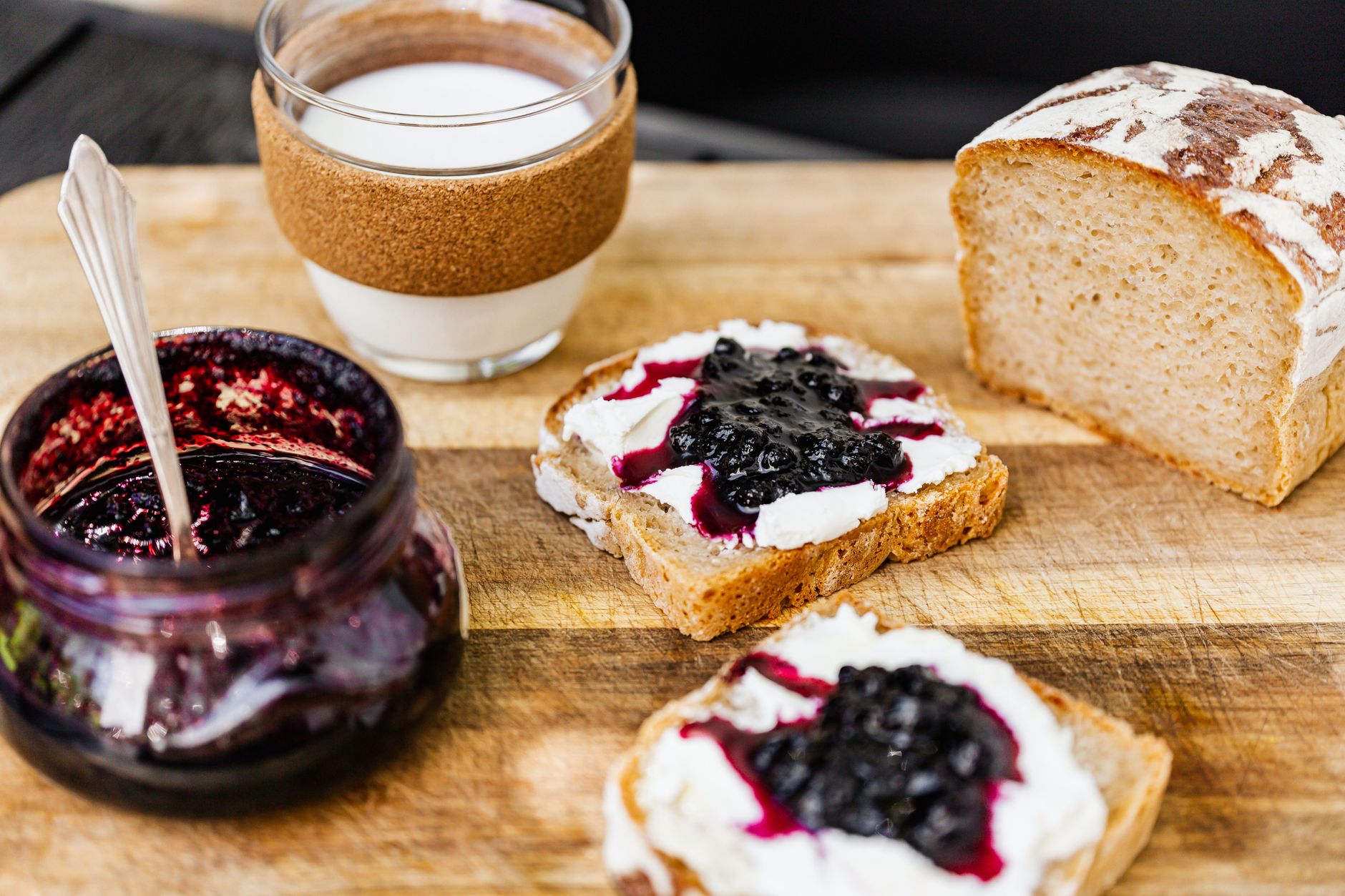 Homemade sweet fruit spread in glass jars on kitchen counter
