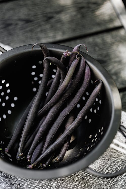 Purple Beans on Black Round Colander