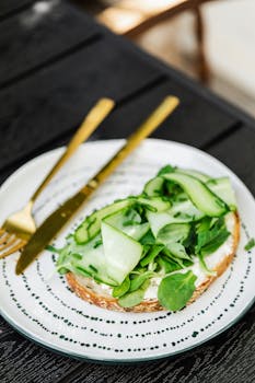 Close-up of a cucumber sandwich on artisan bread with fresh greens, perfect for healthy eating.