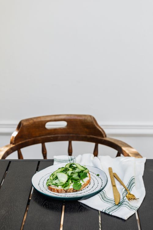 Free Delicious open sandwich with fresh cucumber and cream cheese on a stylish plate. Stock Photo