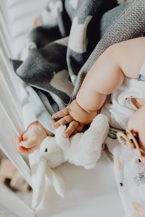 Free Close-up of Baby Infant Lying with Toy Stock Photo