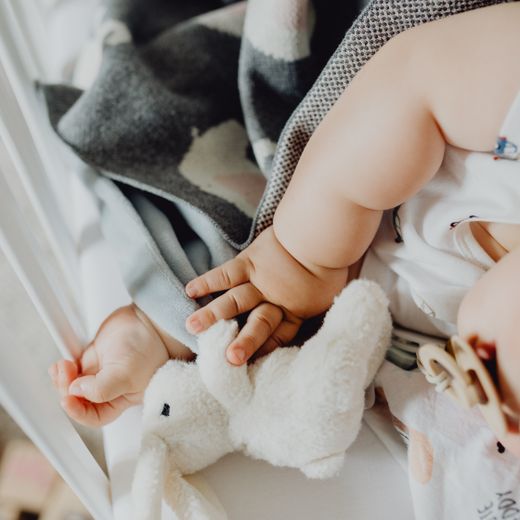 Fitted crib sheet on a baby mattress