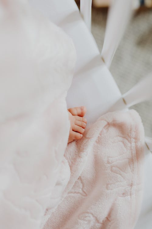 Free Part of a Baby Foot in a Crib Stock Photo