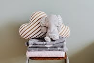 Gray Elephant Plush Toy on White and Black Striped Chair