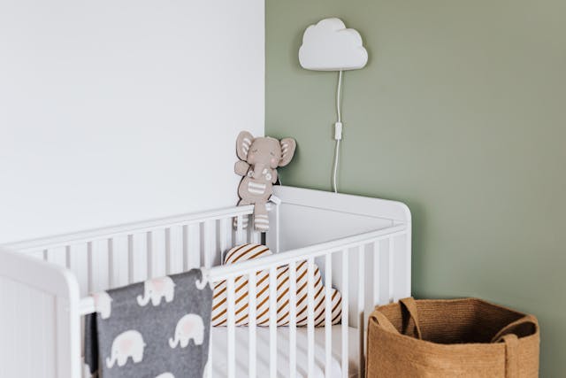 Modern baby nursery room with crib and soft lighting