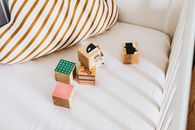 Brown Wooden Blocks on White and Blue Striped Textile