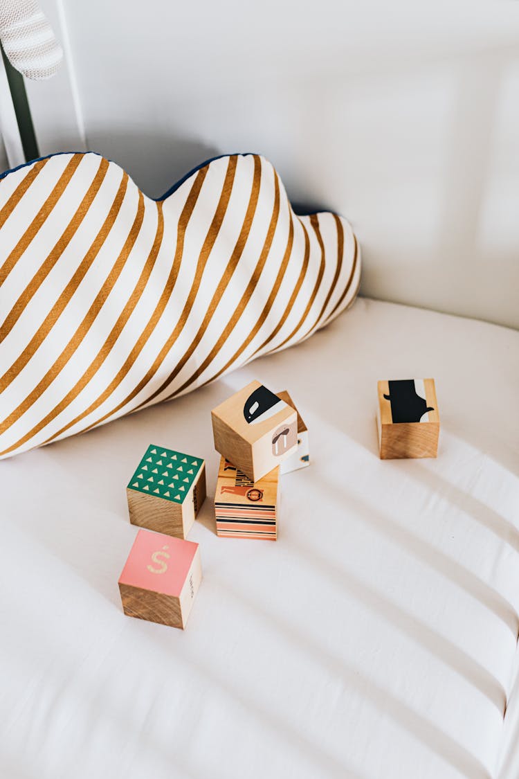 Colorful Playing Blocks Lying On Bed