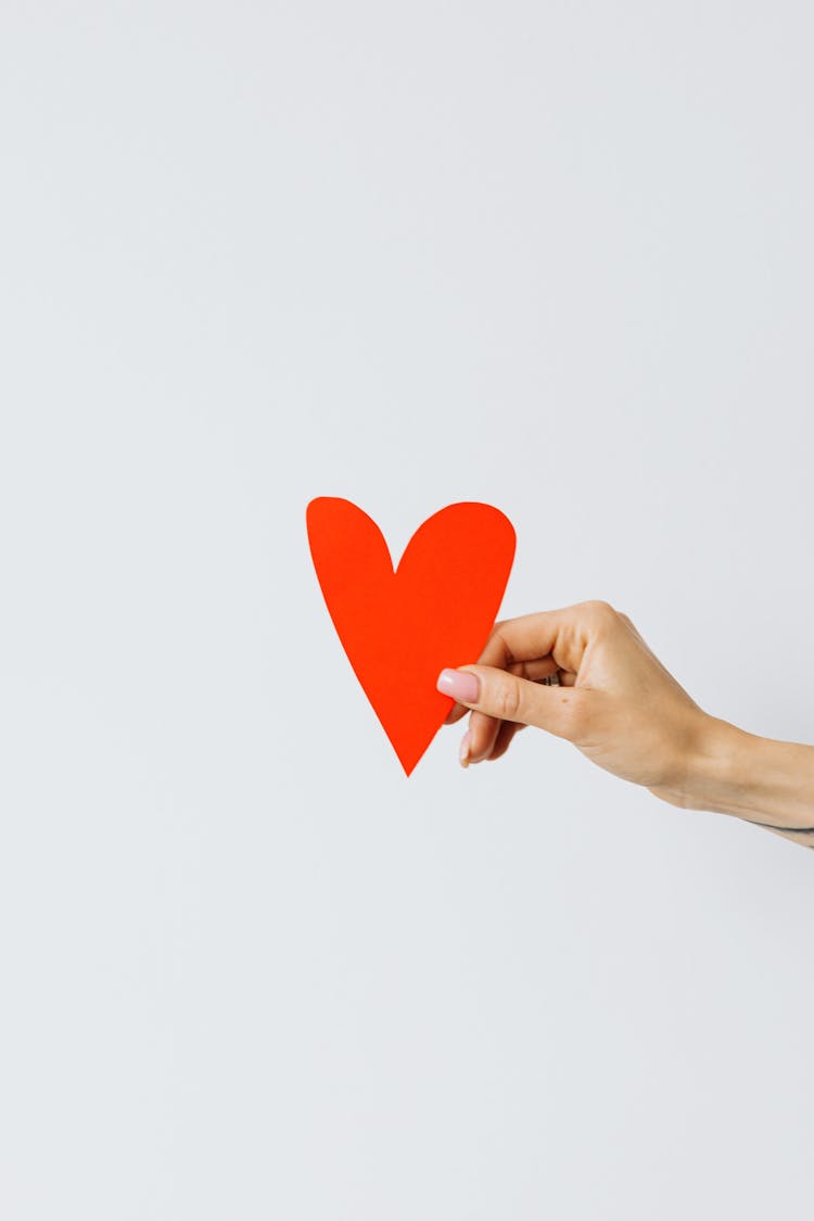 Woman Hand Holding Red Paper Heart