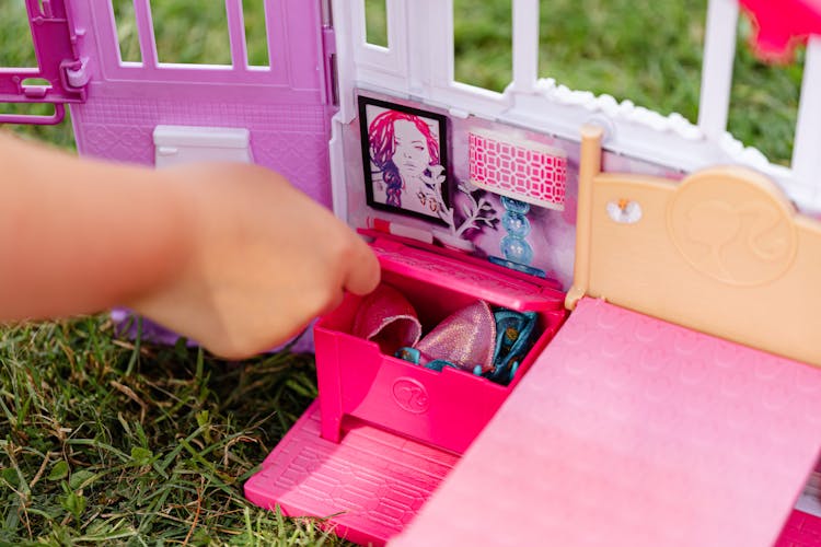 Person Playing Mini Bedroom Toy