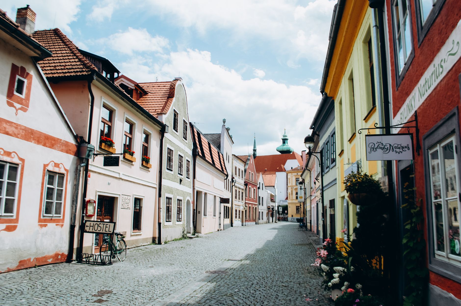Scenic view of a charming European street lined with colorful old-style buildings.