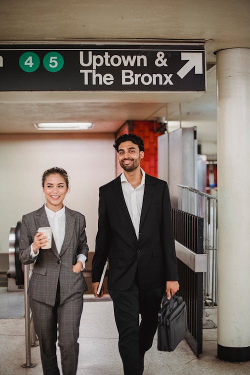 Man and Woman in Formal Attire Walking