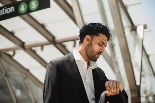 Man in Black Suit Looking at his Wrist Watch