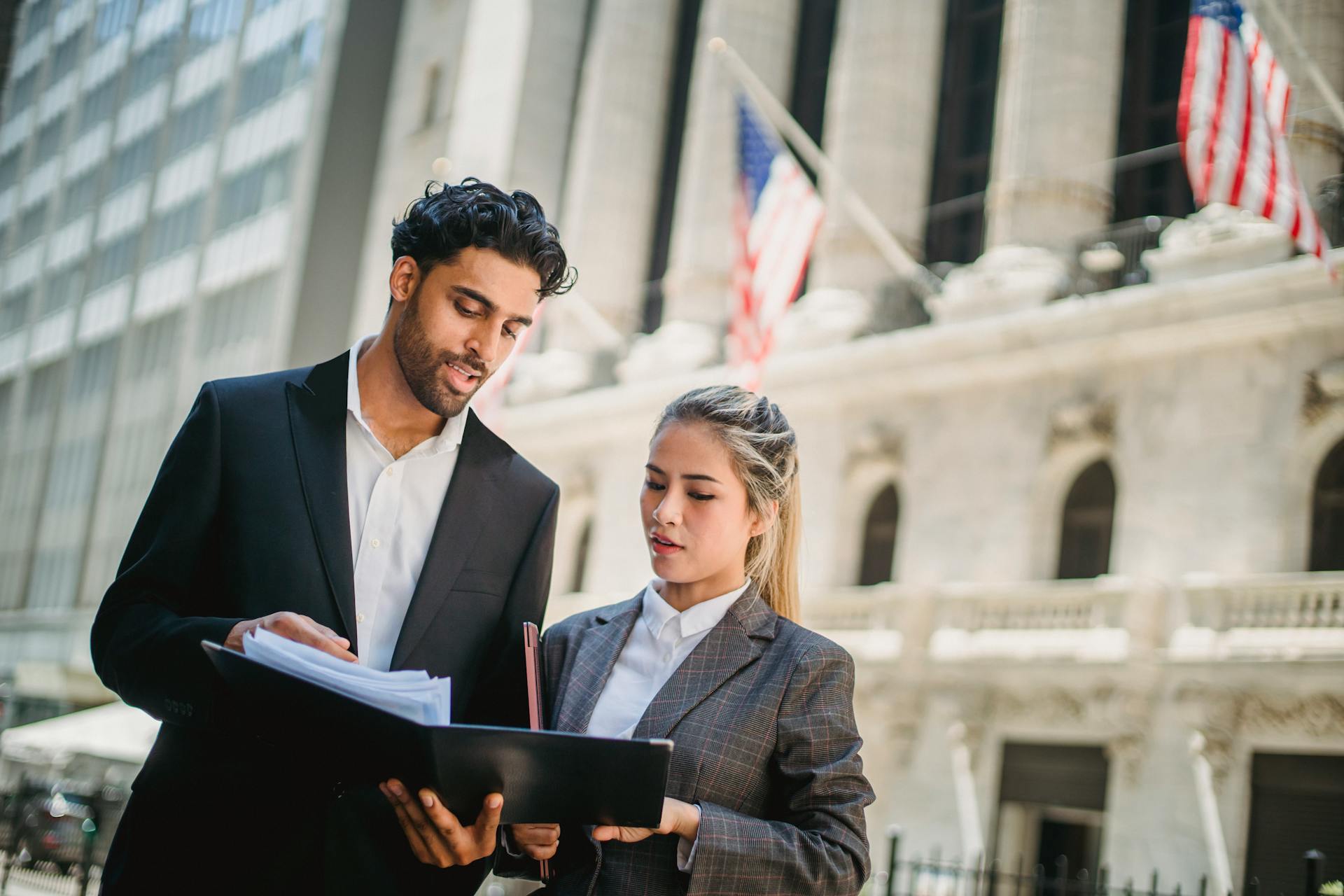 Man Discussing while Holding a Document Binder