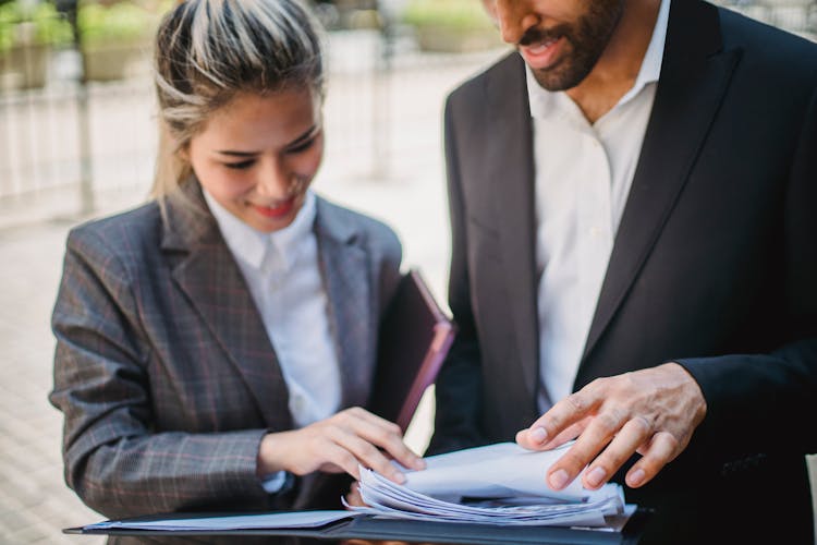 Shallow Focus Shot Of Man And Woman Checking Papers