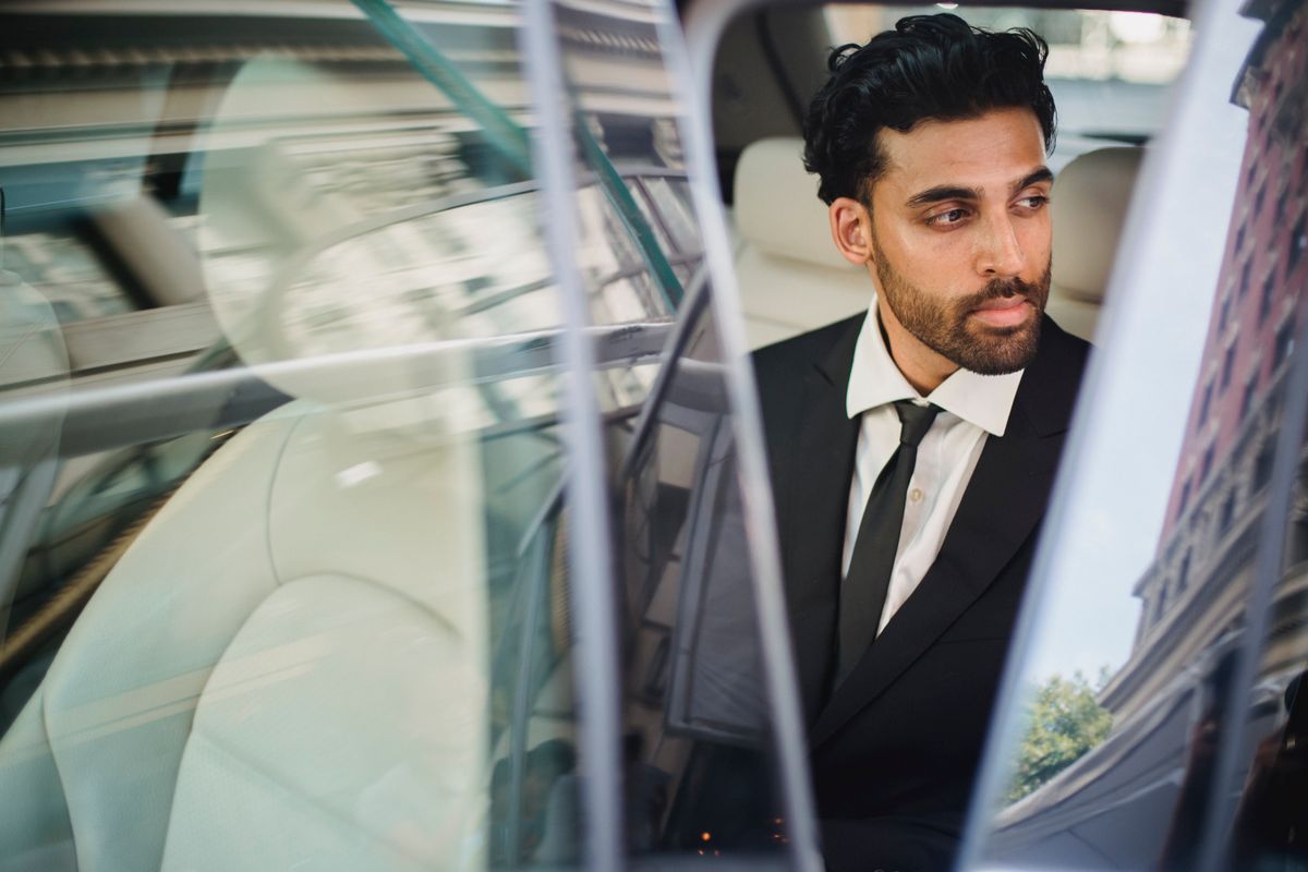 Business traveller in a suit looking out of a car window