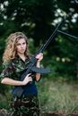 Woman in Green and Black Camouflage Jacket Holding Rifle