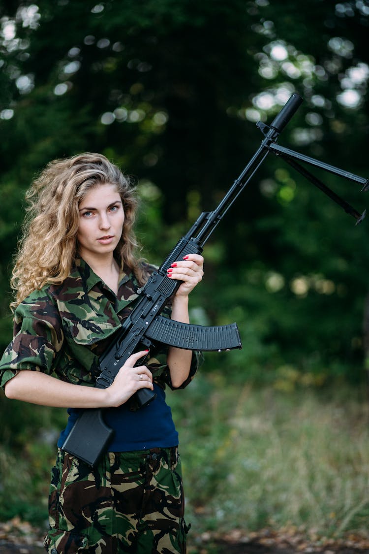 Portrait Of A Woman In A Military Clothing Holding A Rifle